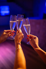 Girls at parties drink champagne and clink glasses