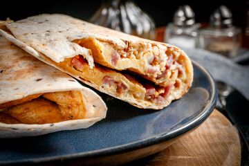 Tortilla multigrain with omelette, sausage and bacon.