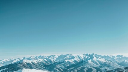 Fototapeta premium Scenic view of a snowy mountain range under a clear blue sky Nature