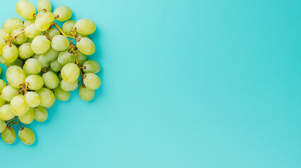 Fresh green grapes on vibrant blue background, perfect for healthy snacks