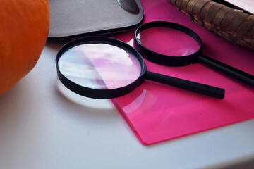 Two magnifying glasses lying on the windowsill.