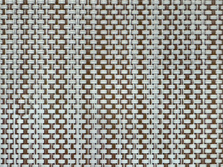 Close up of hand woven synthetic bamboo rattan in vertical stripes pattern. Beige brown bamboo weaving pattern seamless background texture