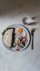 beautiful fresh breakfast on the table with glass of water