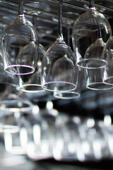 A collection of wine glasses elegantly hanging from a display rack