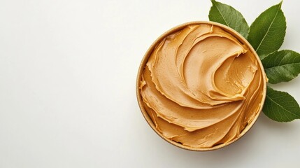 A container filled with creamy peanut butter on a white background
