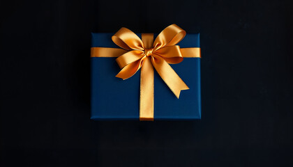 Elegant blue gift box adorned with a golden ribbon on a dark background