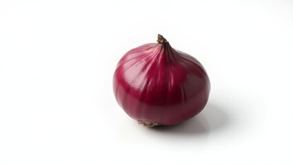 Single red onion bulb resting on white background