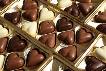 Beautiful heart shaped chocolate candies in box as background