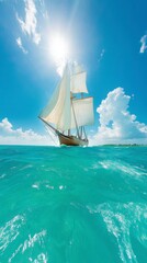 Obraz premium A majestic sailing ship glides over turquoise waters under a bright sun and blue sky, creating a picturesque maritime scene.