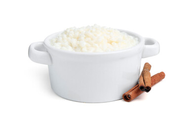 Delicious rice pudding with cinnamon sticks isolated on white