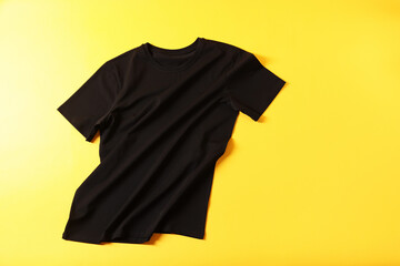 One t-shirt on yellow background, top view. Space for text