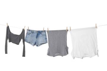 Different clothes drying on laundry line against white background