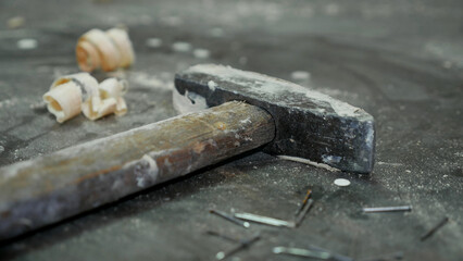 Hammer and nails on an iron table