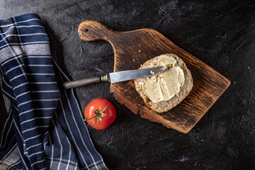 Slice of bread smeared with butter.