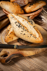 Fresh bread rolls on a rustic wooden table.