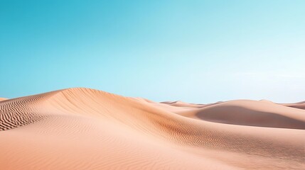 Vast sandy dunes under a clear blue sky near a desert landscape during midday, showcasing the natural beauty and tranquility of the environment