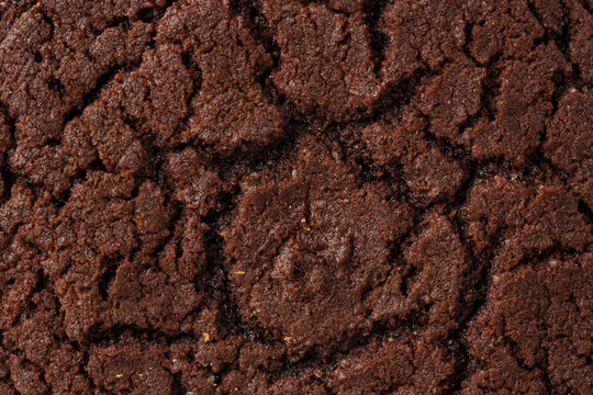 Freshly baked chocolate cookie on a rustic wooden surface after cooling