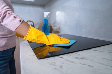 Housekeeper cleaning the kitchen, gas stove, cleanliness concept