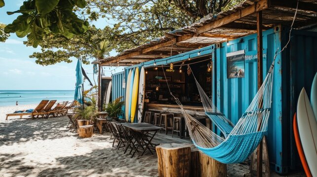Beachfront surf shack with hammock, chairs, and surfboards.