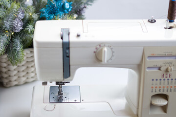 Sewing machine and tailoring, sewing workshop- atelier. Sewing New Year's clothes and Santa Claus hat