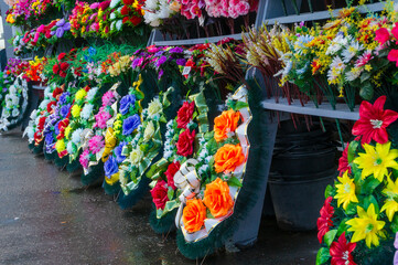 Funeral wreaths made of plastic flower rows, symbols of respect and remembrance, artificial classic...