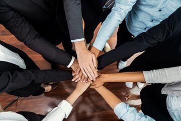 Multiracial business people make synergy hand stack together in meeting room as cooperation or team...