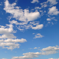 Blue sky with light, cumulus clouds.