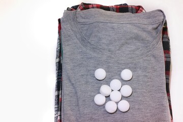 pile of clothes with camphor on top, as a clothes freshener. isolated on white background