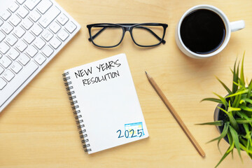 2025 Happy New Year Resolution Goal List and Plans Setting - Business office desk with notebook written about plan listing of new year goals and resolutions setting. Change and elation concept.