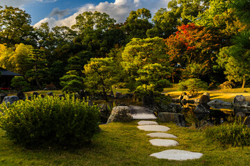 Traditional Japanese garden in early autumn with beautiful setting. Kyoto, Japan