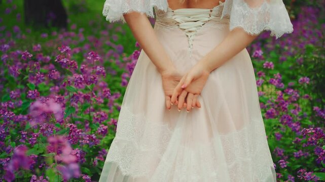 Art portrait beauty blonde hair young woman rear view, medieval lady enjoy summer nature purple flowers forest field. white long dress vintage old style open bare back. Girl elf princess sexy lady 4k
