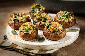 Baked Cremini Mushrooms stuffed with roasted mushrooms legs, with onion, spinach, bread crumbs and goat cheese.