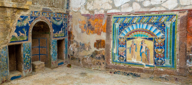 Ruins of reception room in an ancient roman villa with colorful wall mosaics, Herculaneum archaeological site, Ercolano, Campania, Italy