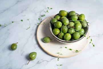 A bowl of marinated green olives, healthy eating, fermented foods.