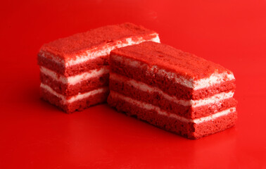 pieces of red cake on a red background