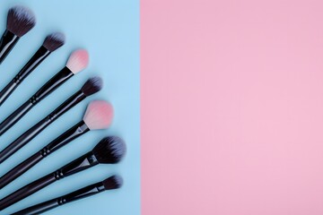 Naklejka premium Black-handled makeup brushes arranged in a fan shape on a pink and blue background, Minimalistic beauty concept