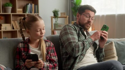 Family device overuse. Caucasian male daddy parent man typing screen mobile phone schoolgirl child addiction girl play virtual game at home family father dad guy kid daughter ignoring each other tech