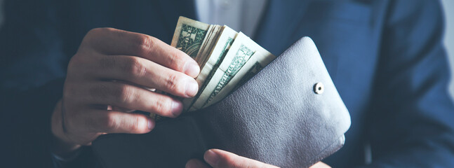 Businessman hand money from a wallet