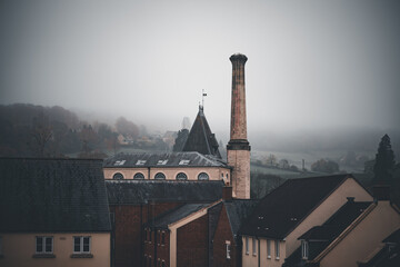 Old Cotswold Mill in winter misty hills