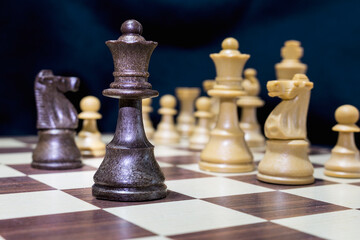 Chessmen photographed on a chessboard with a dark background