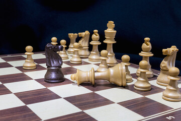 Chessmen photographed on a chessboard with a dark background