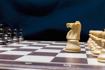 Chessmen photographed on a chessboard with a dark background
