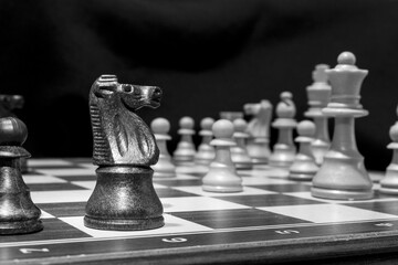 Chessmen photographed on a chessboard with a dark background