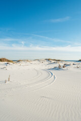 Tire Tracks on White Beach Sand