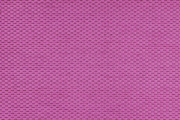 Plain pink jacquard upholstery fabric, satin material with woven structure, pattern texture background. Close up, macro cloth textile surface. Wallpaper, backdrop with copy space