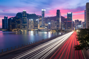 Fototapeta premium Vibrant cityscape with water reflections and light trails, colorful twilight sky