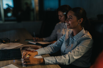 Business people working diligently in a late-night meeting at the office. The focus is on teamwork, dedication, and productivity, highlighting the dynamic environment of a corporate setting.