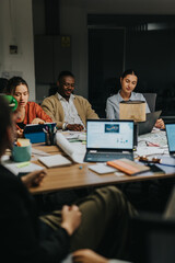 A focused group of colleagues collaborating on a project in a dimly lit office during late hours....