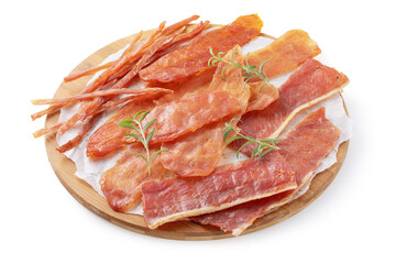 Four types of pork, chicken and turkey meat chips with rosemary sprigs on a round wooden tray isolated on a white background, smoked beer snack