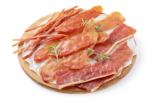 Four types of pork, chicken and turkey meat chips with rosemary sprigs on a round wooden tray isolated on a white background, smoked beer snack